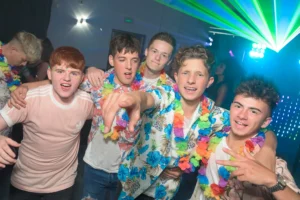 A group of friends at a prom dance .Mobile disco setup in the background. Lasers and lights fill the air.