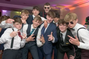 A group of students pose for a picture at a school prom disco. 